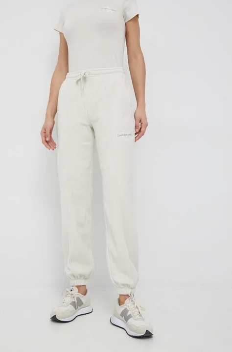 Calvin Klein Jeans pantaloni de trening femei, culoarea bej, cu imprimeu