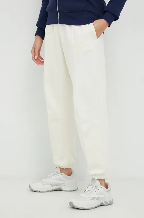New Balance spodnie dresowe bawełniane damskie kolor beżowy gładkie