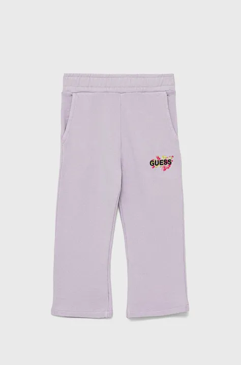 Дитячі бавовняні штани Guess колір фіолетовий з аплікацією