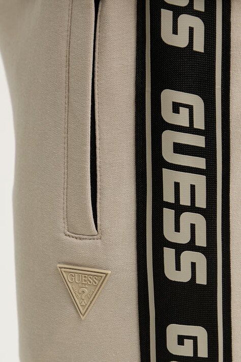 Guess spodnie dresowe kolor beżowy z nadrukiem