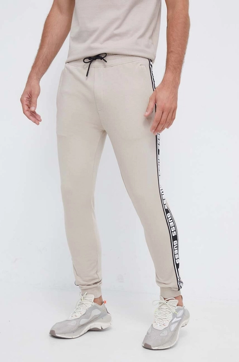 Guess pantaloni de trening culoarea maro, cu imprimeu