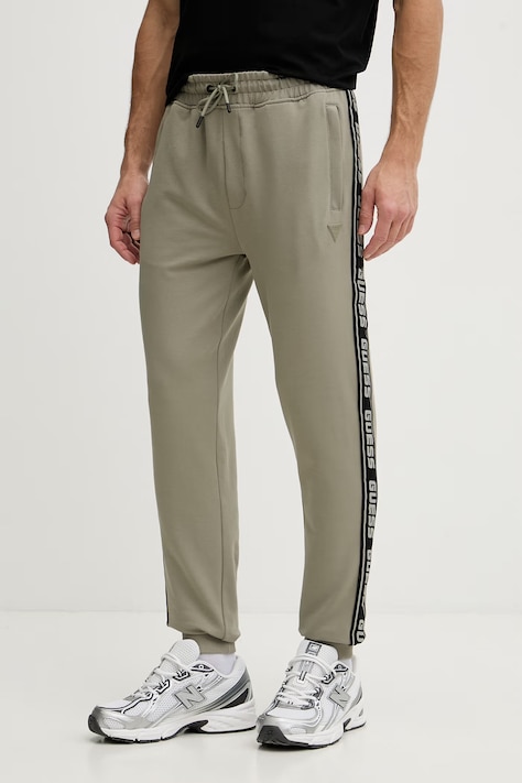 Tepláky Guess béžová farba, s potlačou