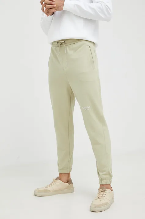 Bombažne trenirke Calvin Klein Jeans moško, zelena barva
