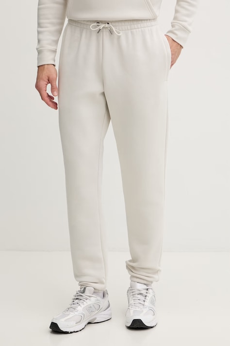 Under Armour spodnie dresowe męskie z bawełną Essential Fleece beżowe regular waist 1373882