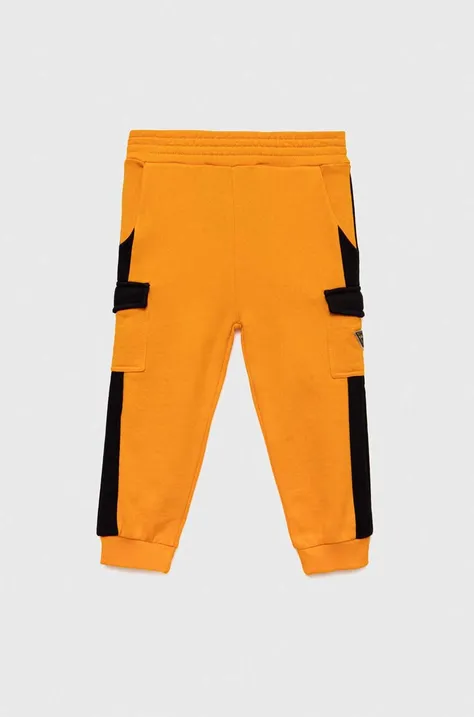 Дитячі бавовняні штани Guess колір помаранчевий візерунок