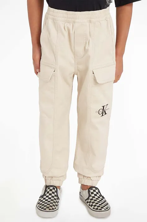 Dětské kalhoty Calvin Klein Jeans béžová barva, hladké