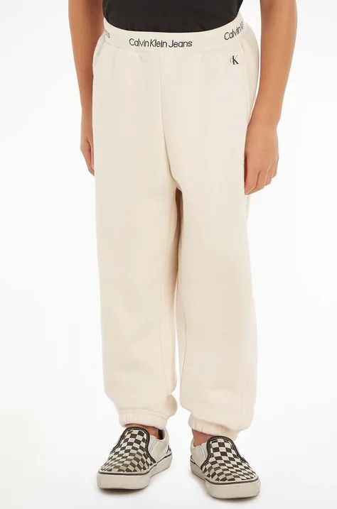 Calvin Klein Jeans pantaloni de trening pentru copii culoarea bej, neted