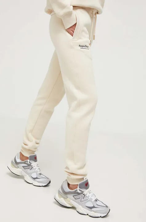 Superdry spodnie dresowe kolor beżowy gładkie