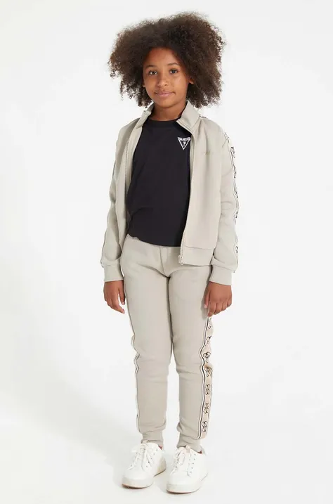 Дитячі спортивні штани Guess колір бежевий візерунок