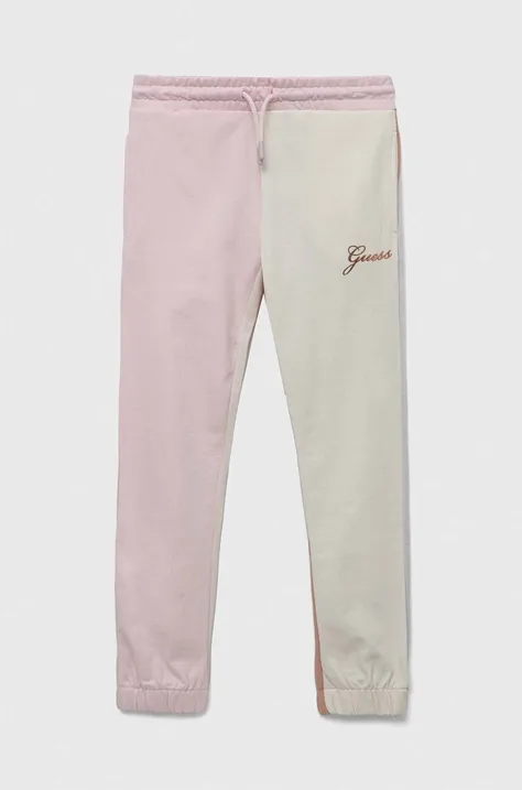 Guess spodnie dresowe bawełniane dziecięce kolor różowy wzorzyste