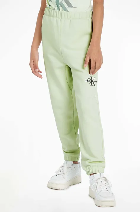 Dětské tepláky Calvin Klein Jeans zelená barva, hladké