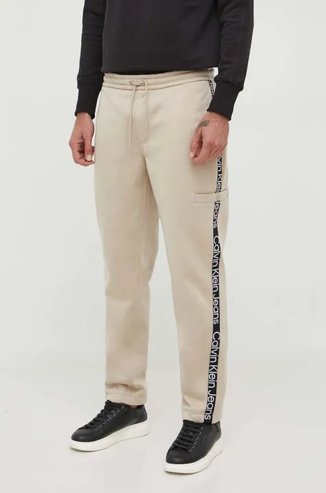 Tepláky Calvin Klein Jeans béžová farba, s nášivkou