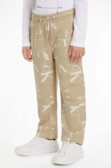 Детские хлопковые штаны Calvin Klein Jeans TERRY JOGGER цвет бежевый с узором IB0IB02124