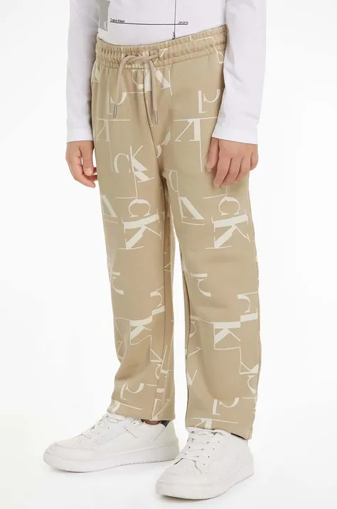 Дитячі бавовняні штани Calvin Klein Jeans TERRY JOGGER колір бежевий візерунок IB0IB02124