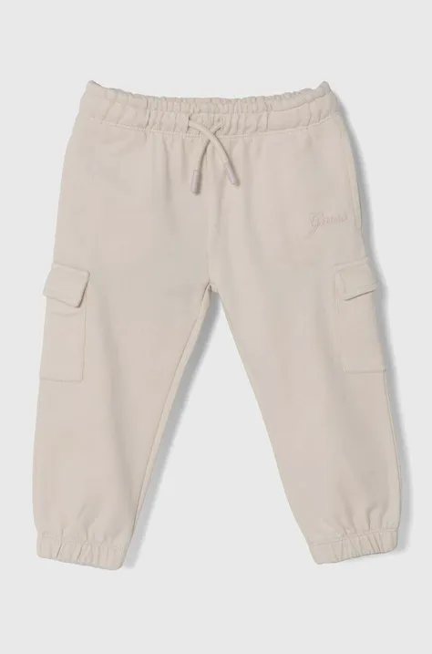 Guess spodnie dresowe bawełniane dziecięce kolor beżowy gładkie K4YQ12 KA6R3