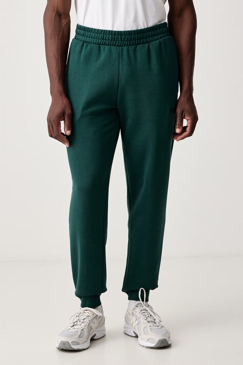 Puma Spodnie dresowe męskie z bawełną Essential Logo zielone regular waist 682607