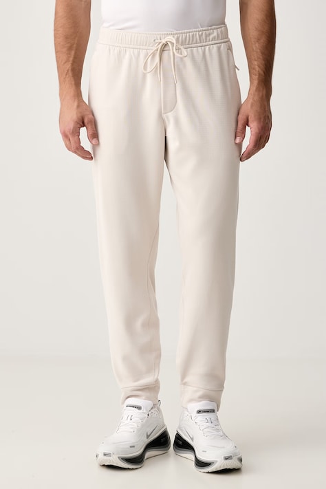 Nike Spodnie treningowe męskie Primary NanoKnit Therma-FIT beżowe regular waist IM7219.104