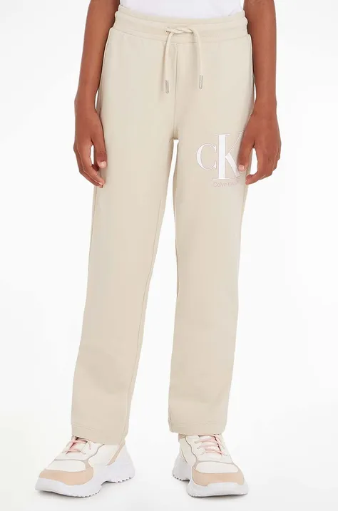 Detské tepláky Calvin Klein Jeans béžová farba, vzorované