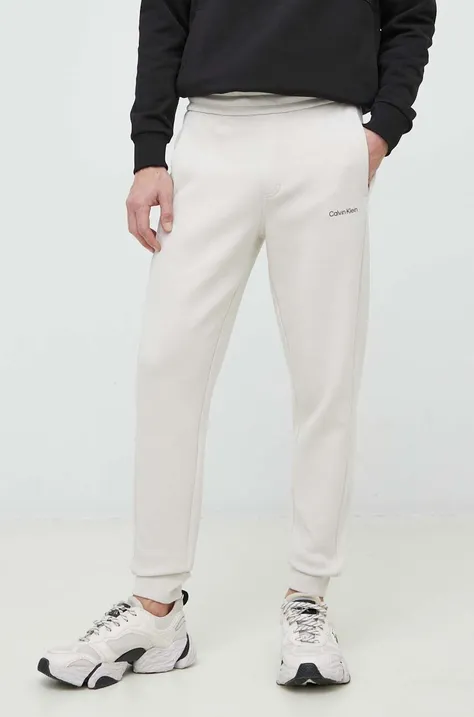 Спортивные штаны Calvin Klein мужские цвет бежевый однотонные