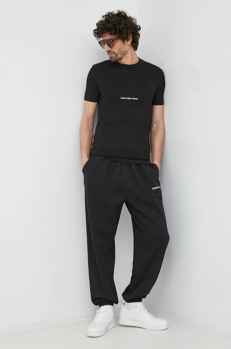 Donji dio trenirke Calvin Klein Jeans boja: crna, s aplikacijom