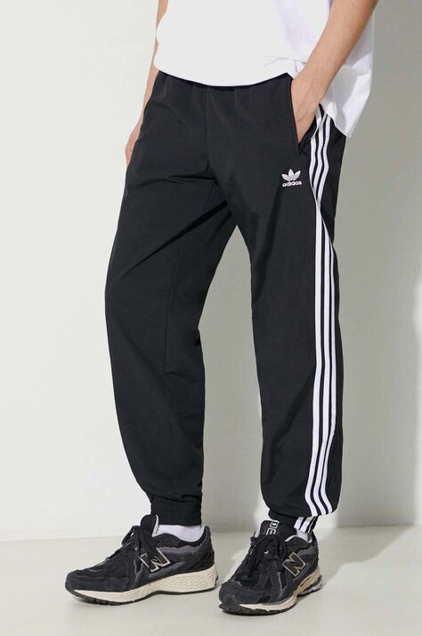 Брюки adidas Originals Adicolor Woven Firebird Track Top мужские цвет чёрный с узором IT2501