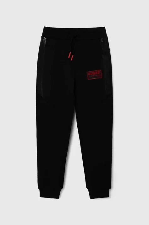 Дитячі спортивні штани Guess колір чорний з аплікацією