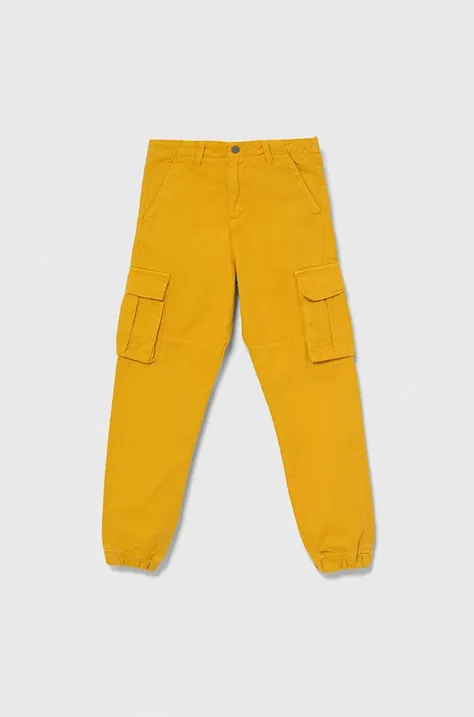 Guess spodnie bawełniane dziecięce kolor żółty gładkie