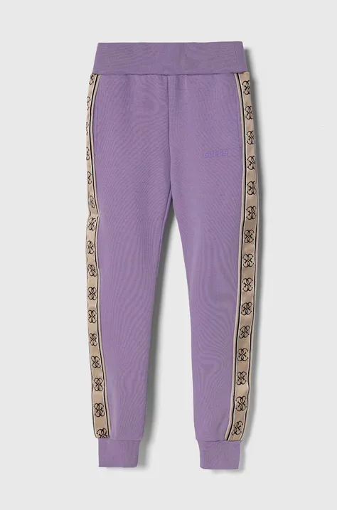 Дитячі спортивні штани Guess колір фіолетовий з аплікацією