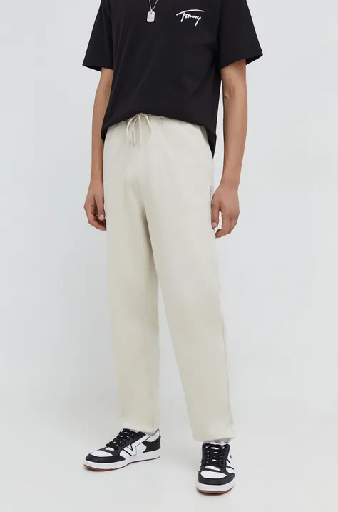 Tommy Jeans spodnie dresowe bawełniane kolor beżowy gładkie