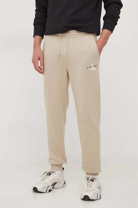 Calvin Klein Jeans spodnie dresowe kolor beżowy z nadrukiem