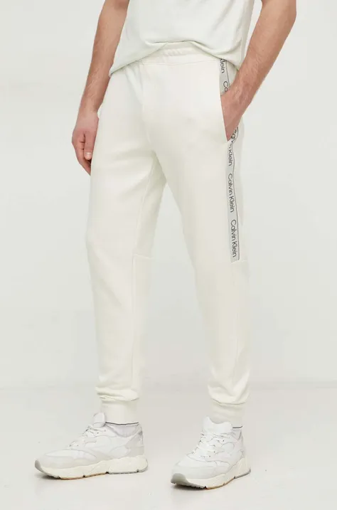 Calvin Klein pantaloni de trening culoarea bej, cu imprimeu K10K112945