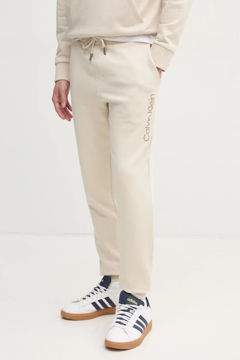 Хлопковые спортивные штаны Calvin Klein цвет бежевый с аппликацией K10K114254