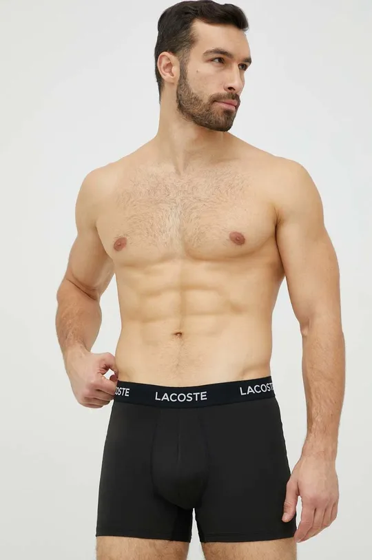 Boxerky Lacoste  Základná látka: 91 % Polyester, 9 % Elastan Elastická manžeta: 59 % Polyamid, 27 % Polyester, 14 % Elastan