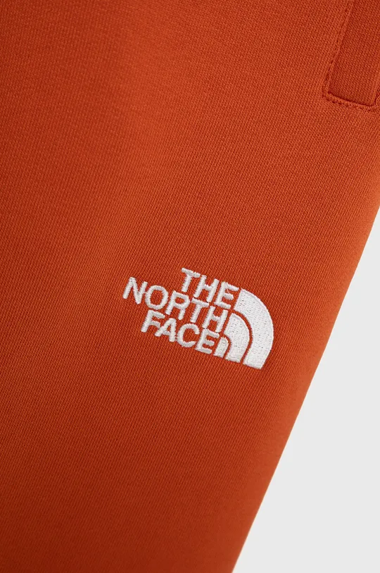 Παιδικό βαμβακερό παντελόνι The North Face πορτοκαλί
