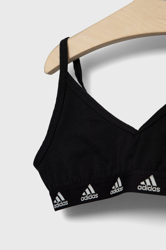 Detská podprsenka adidas  1. látka: 72% Recyklovaný polyamid, 15% Elastan, 13% Polyamid 2. látka: 74% Recyklovaný polyester, 19% Bavlna, 7% Elastan