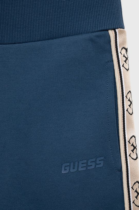 Dětské tepláky Guess  Hlavní materiál: 75% Bavlna, 25% Polyester