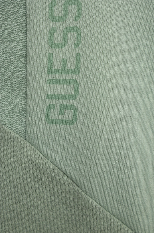 Detské tepláky Guess  1. látka: 60% Bavlna, 40% Polyester 2. látka: 98% Bavlna, 2% Polyester