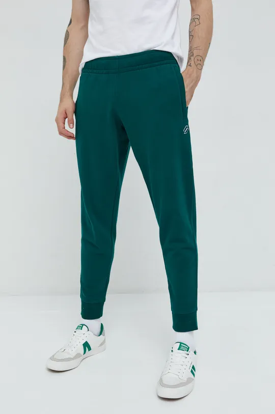 Бавовняні спортивні штани Superdry зелений