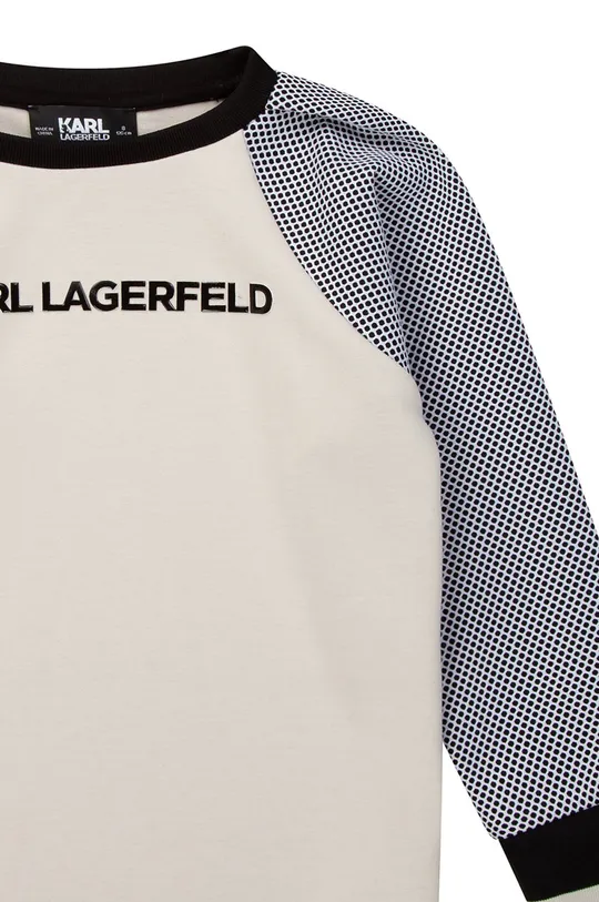 Dječja haljina Karl Lagerfeld  Temeljni materijal: 72% Poliester, 24% Viskoza, 4% Elastan Drugi materijali: 57% Pamuk, 37% Modal, 6% Elastan Manžeta: 97% Poliester, 3% Elastan