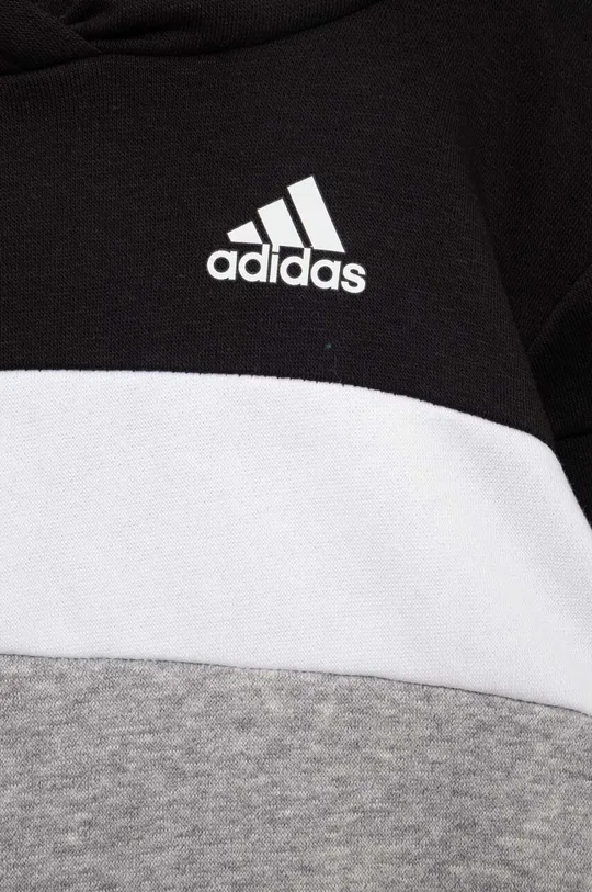 Otroška trenirka adidas  Material 1: 70 % Bombaž, 30 % Poliester Material 2: 93 % Bombaž, 7 % Elastan