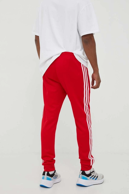 Tepláky adidas Originals  70 % Recyklovaný polyester, 30 % Bavlna