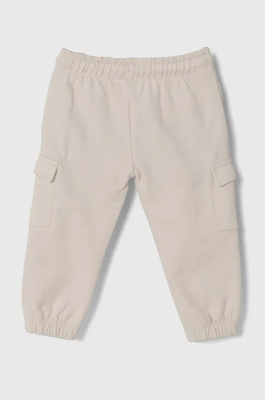 Guess spodnie dresowe bawełniane dziecięce beżowy
