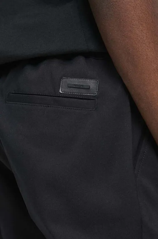 Spodnie męskie gładkie kolor czarny Materiał zasadniczy: 57 % Bawełna, 40 % Poliester, 3 % Elastan, Inne materiały: 60 % Bawełna, 40 % Poliester