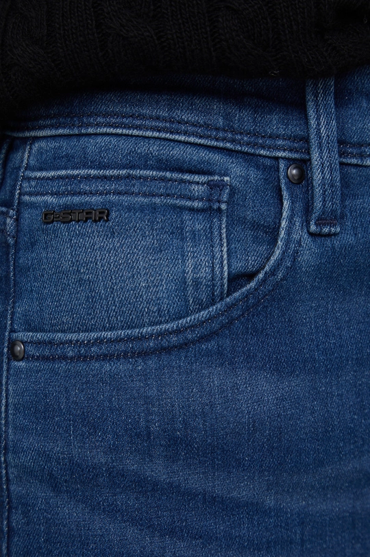 Traperice G-Star Raw Kafey  Temeljni materijal: 92% Pamuk, 2% Elastan, 6% Elastomultiester Postava džepova: 35% Organski pamuk, 65% Reciklirani poliester