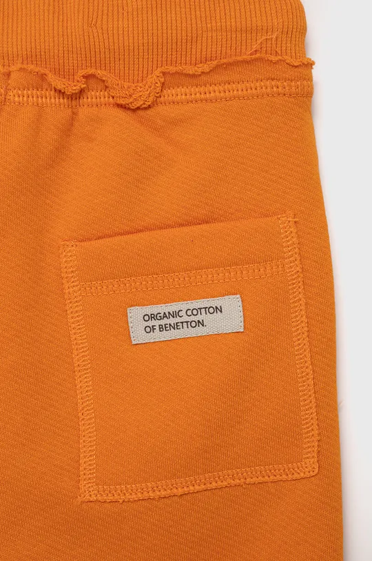 Детские хлопковые брюки United Colors of Benetton оранжевый