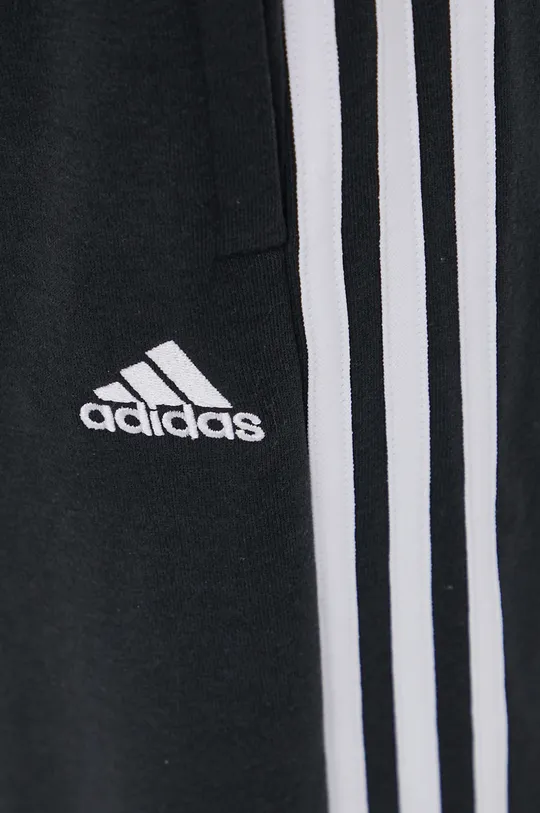 Hlače adidas  53 % Bombaž, 36 % Recikliran poliester, 11 % Rayon