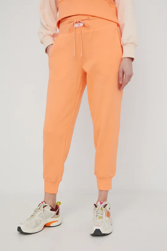 pomarańczowy New Balance spodnie dresowe bawełniane WP21503PGZ Damski