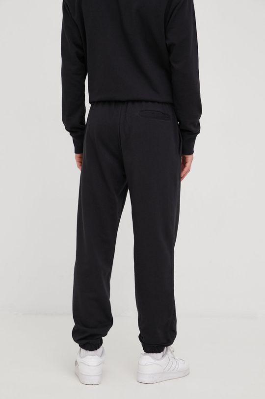 New Balance spodnie dresowe UP21500BK 60 % Bawełna, 40 % Poliester
