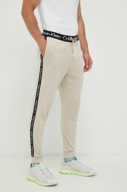 beżowy Calvin Klein Performance spodnie dresowe Active Icon Męski
