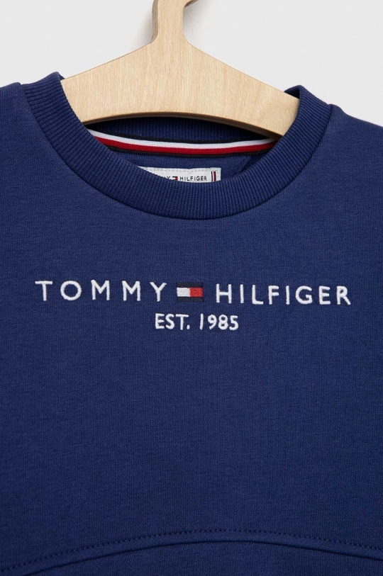 Dječja trenirka Tommy Hilfiger  Temeljni materijal: 78% Pamuk, 22% Poliester Manžeta: 95% Pamuk, 5% Elastan